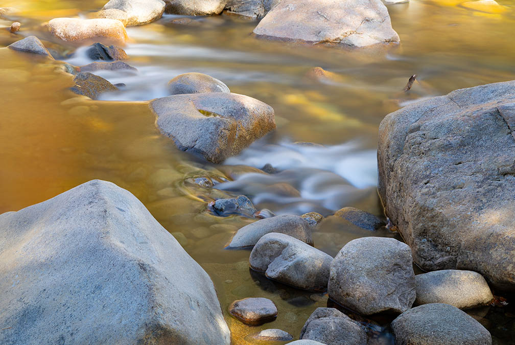 Creamy foliage reflections in the Swift River during the fall color season. Lower Falls Long Exposure