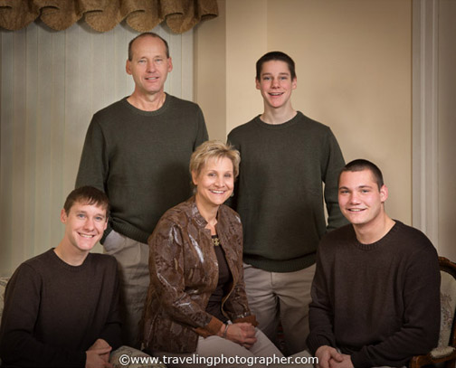 Family portrait on Mom, Dad, and three sons at home in the living room